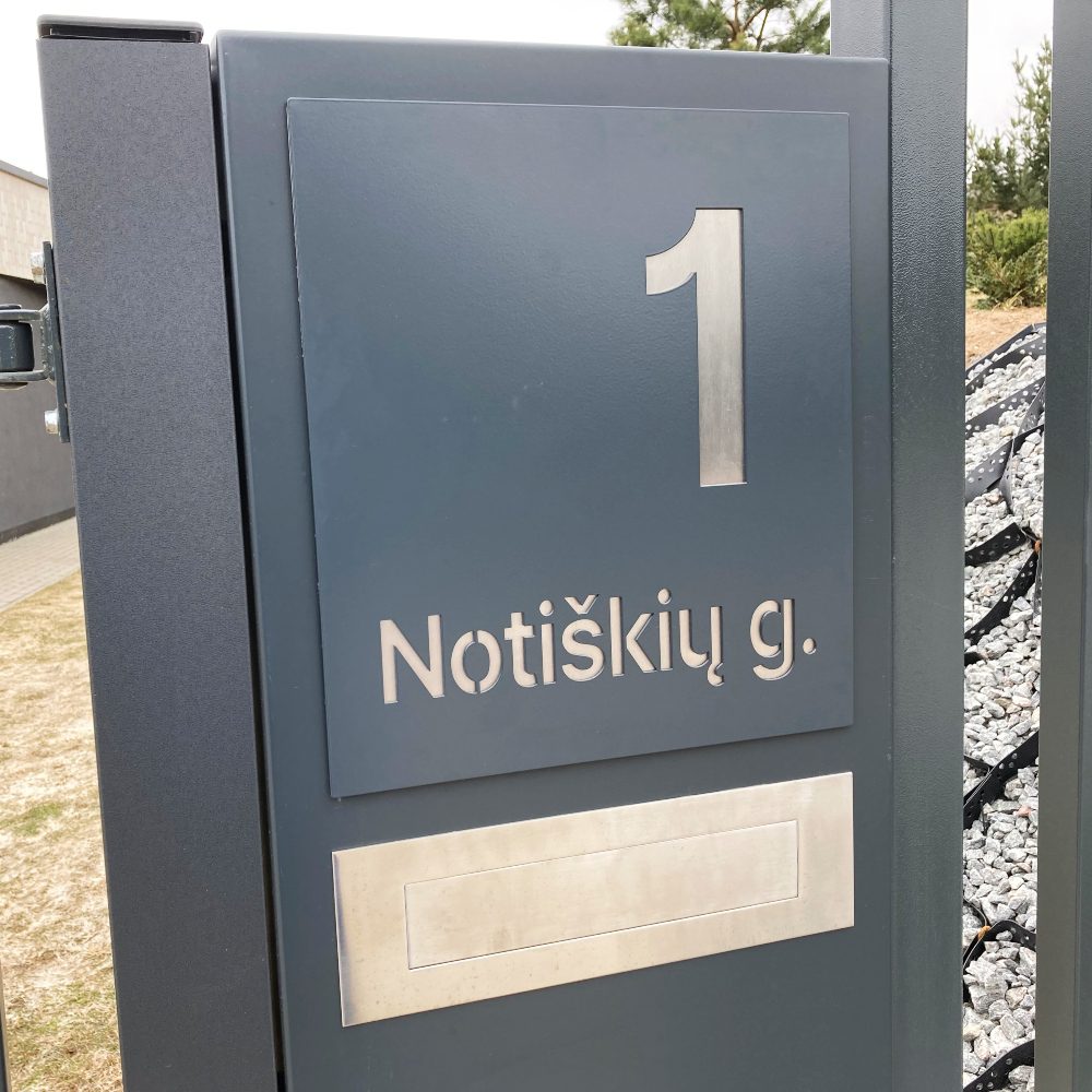 Gatvės pavadinimu ir numeriu 1 pažymėtas kiemo vartų stulpas.